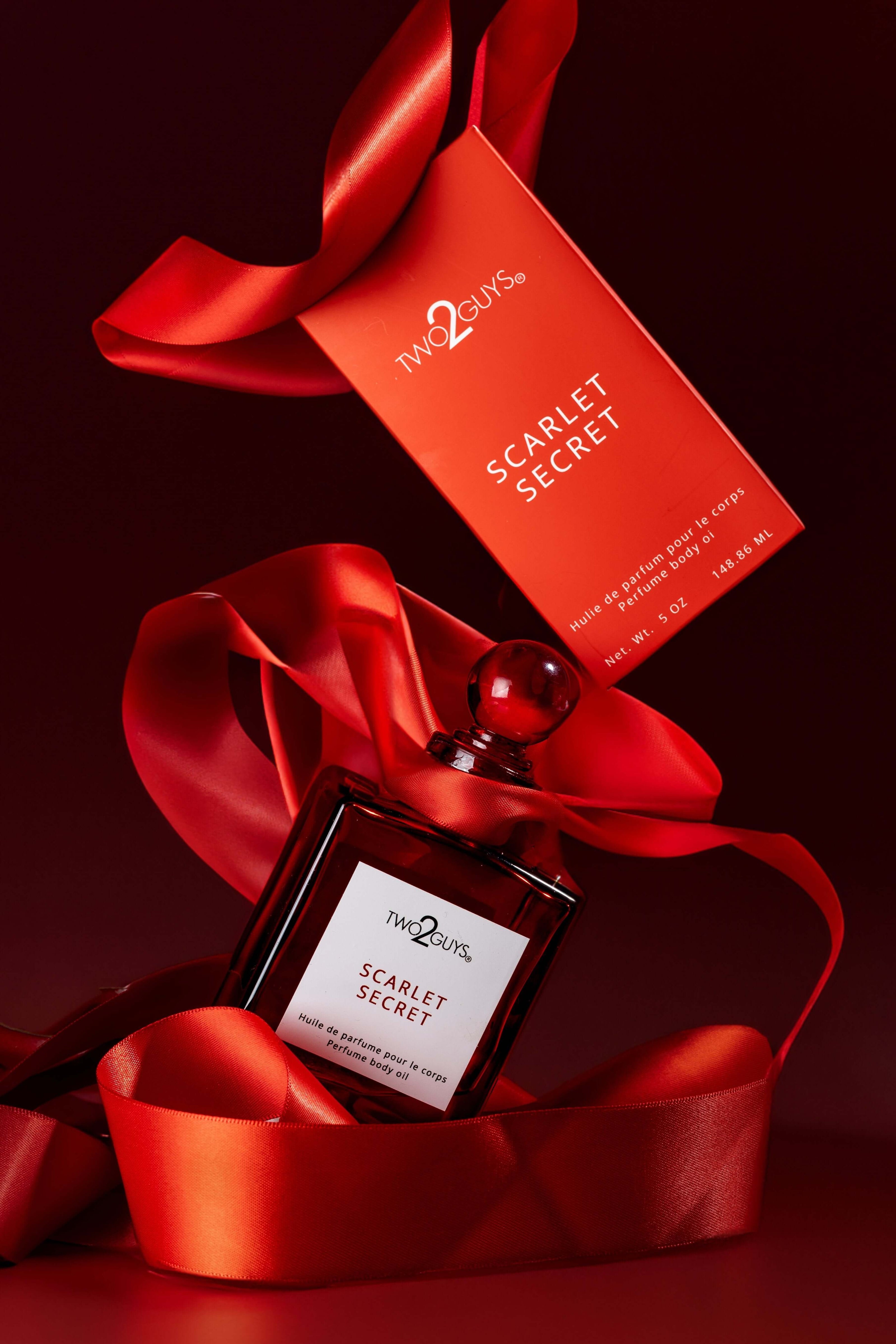SCARLET SECRET PERFUME BODY OIL WITH A RED RIBBON AND RED BOX PACKAGING
