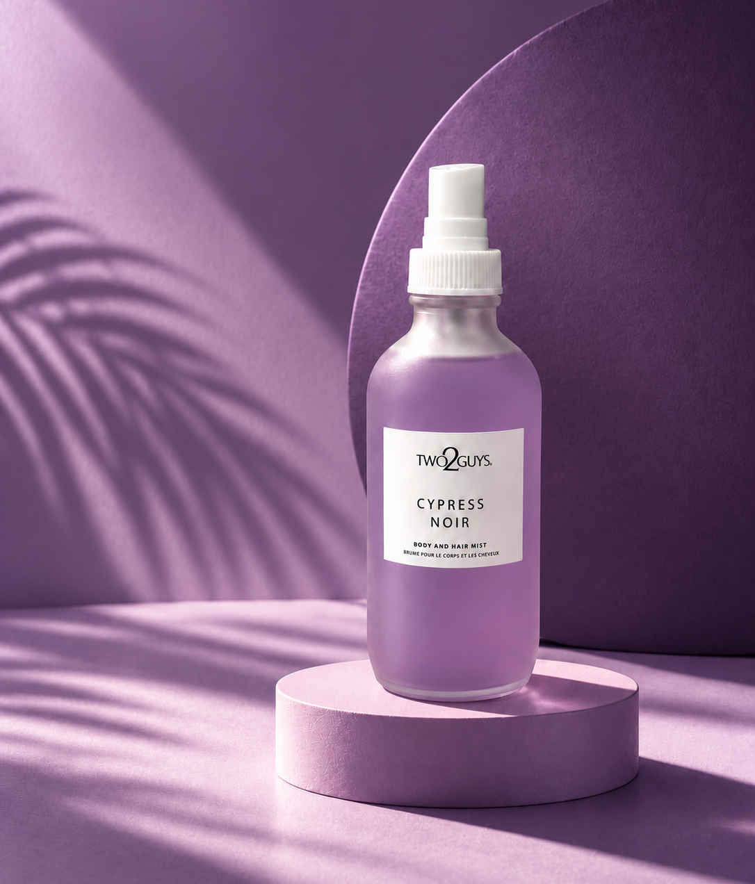 A frosted glass spray bottle of Two2Guys Cypress Noir hair wash, displayed on a matching lavender pedestal against a purple background with soft leaf shadows.