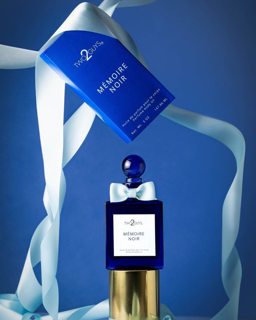 Two2Sins Memoire Noir perfume bottle with blue cap and gold base on a blue background
