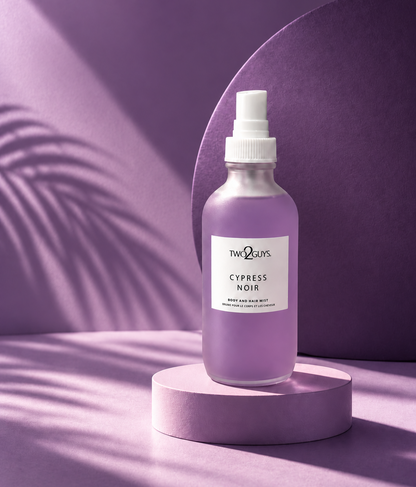 A frosted glass spray bottle of Two2Guys Cypress Noir hair wash, displayed on a matching lavender pedestal against a purple background with soft leaf shadows.